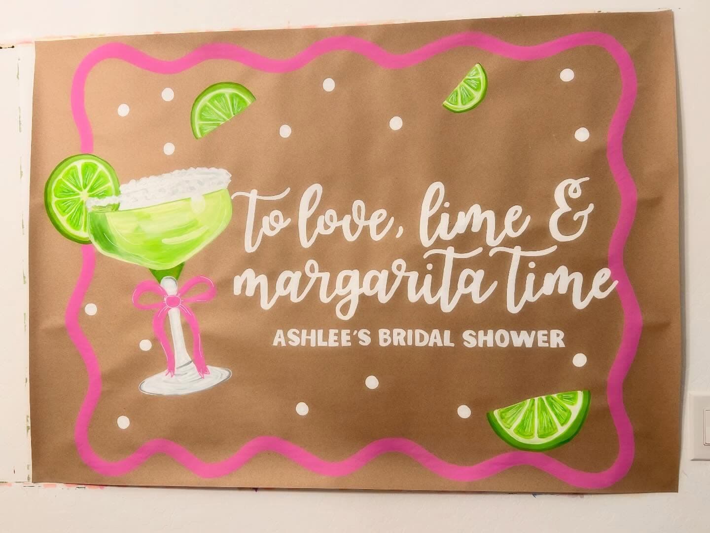 Hand-painted bridal shower banner peeking out behind the main photo